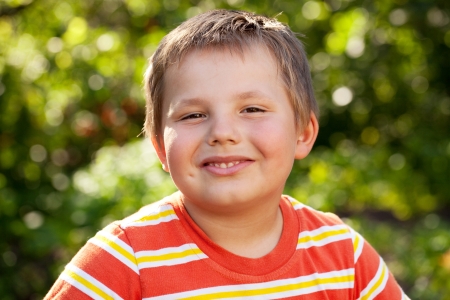 Merry brown-eyed boy, dressed in a striped t-shirtの写真素材