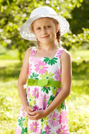 Lovely blonde girl in a hat and summer dressの写真素材