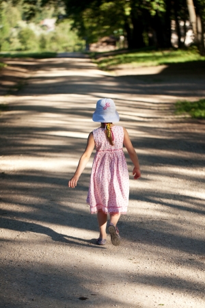 Little girl is alone on the roadの写真素材