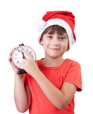 Smiling girl in a Santa Claus hat and alarm clockの写真素材