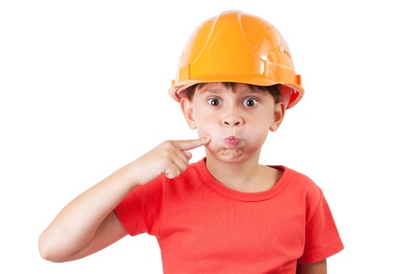 Little girl in a protective helmet deflates mouthの写真素材