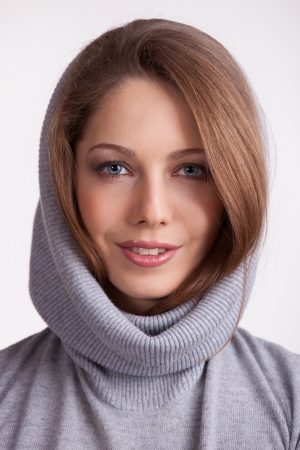 Beautiful charming girl in a wool gray sweaterの写真素材