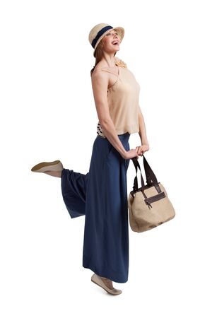 Enthusiastic fashionable woman in a straw hatの写真素材