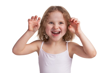 Little cheerful blonde girl playfully scare someoneの写真素材