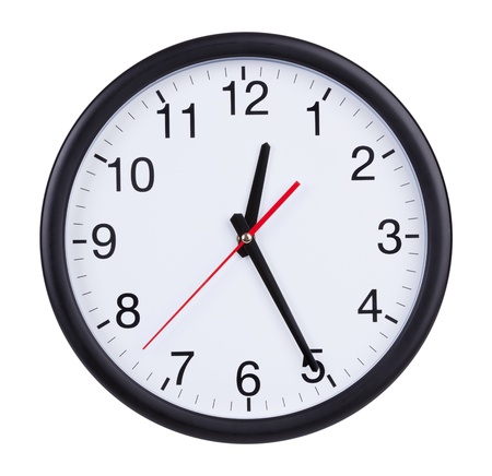 Round office clock shows half of the firstの写真素材