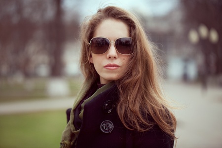 Long-haired young woman in a stylish fashion sunglassesの写真素材