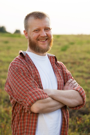Happy smiling red-bearded man in a shirtの写真素材