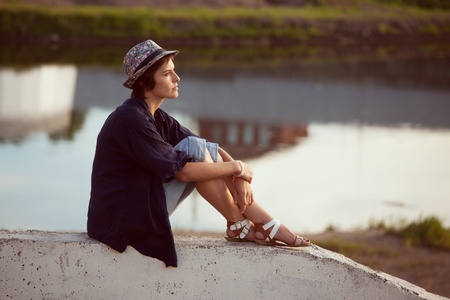 Young woman in a hat sits and restsの写真素材