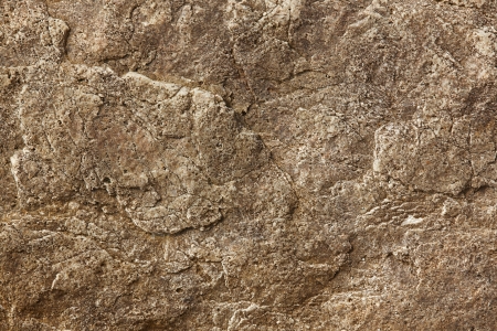 Brown stone surface with cracks on the surfaceの写真素材