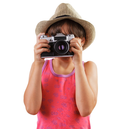 Little girl in a straw hat photographing someoneの写真素材
