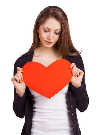 Pretty young woman holding a red heartの写真素材