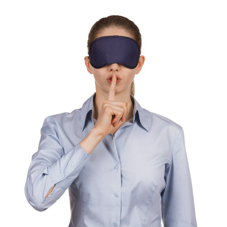 Pretty young woman blindfolded calls for silenceの写真素材