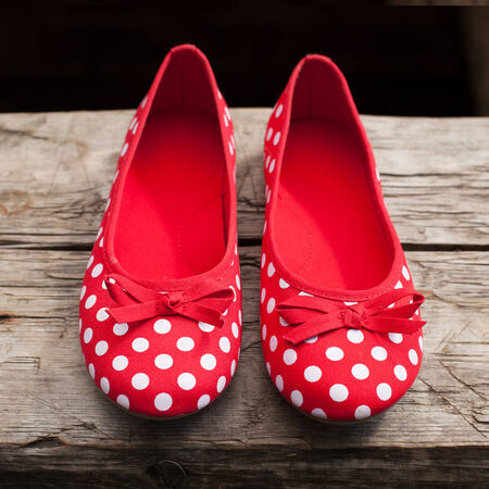 Female shoes made ââof red cloth with white circlesの写真素材