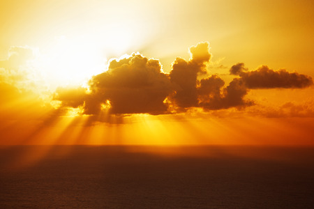 Evening sun disappeared behind a big cloud over oceanの写真素材