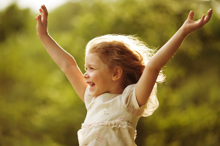 Happy girl with arms outstretched to the sidesの写真素材