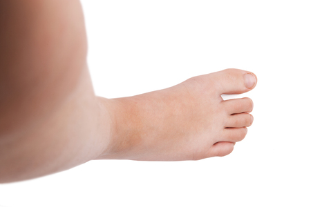 Foot of man standing on a white backgroundの写真素材