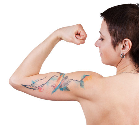 Young woman with a tattoo showing bicepsの写真素材