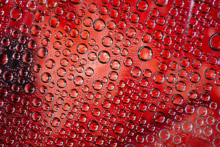 Plurality of transparent bubbles on a red backgroundの写真素材