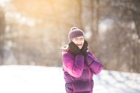 Portrait of a happy girl in a knitted hatの写真素材