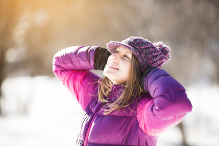 Joyful happy girl in a hat in the sunの写真素材