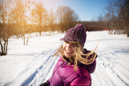 Girl in the knitted hat laughs merrilyの写真素材