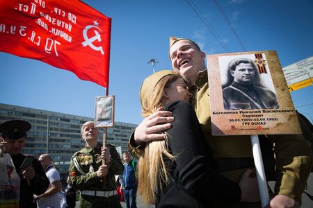 MOSCOW, RUSSIA - MAY 9, 2018: The guy and the girl in the field team during the action "Immortal Regiment" in honor of the memory of those killed in World War II.のeditorial素材