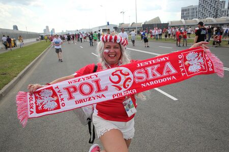 MOSCOW, RUSSIA - JUNE 2018: A woman from Poland walks with a scarf in support of her teamのeditorial素材