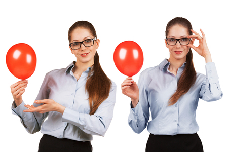 Playful girl in glasses with a puffed red ballの写真素材