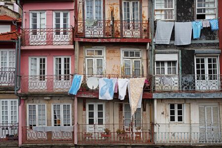View of the facades of houses with balconies where clothes are driedの写真素材