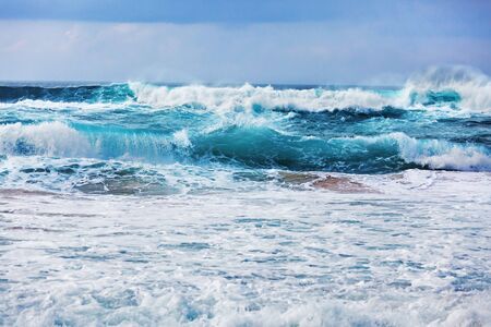 Raging atlantic ocean with waves rolling ashoreの写真素材