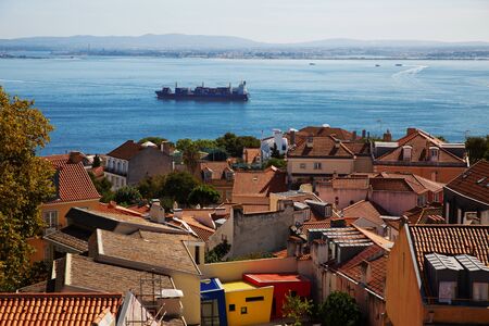 Landscape with urban houses and a ship in the oceanの写真素材