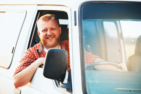 Cheerful bearded blonde driver driving his carの写真素材