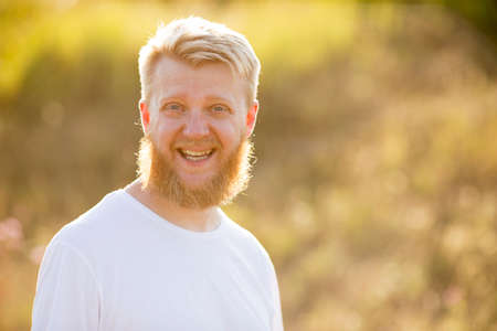 Cheerful bearded young man in white t-shirtの写真素材