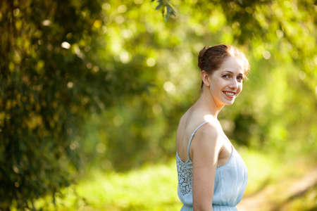 Portrait of a beautiful young woman in a blue dressの写真素材