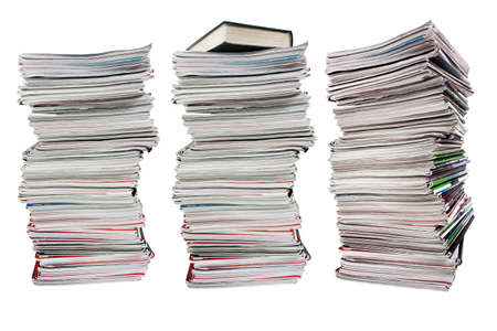 Tall stack of old magazines and book on white backgroundの写真素材