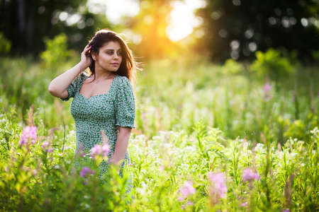 Beautiful happy girl with dark hair among the fieldの写真素材