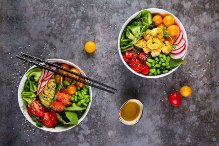 Two plates with poke and olive oil on gray background. Flat layの写真素材