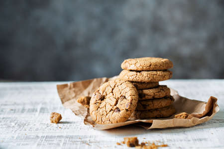 Stack of fresh oatmeal cookies with chocolate lies on a white tableの写真素材