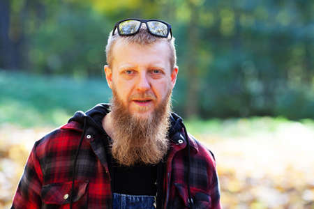 Portrait of a bearded young man in a plaid shirtの写真素材