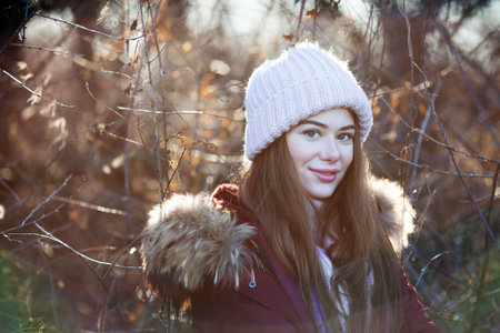 Portrait of a beautiful young woman in a knitted pink hatの写真素材