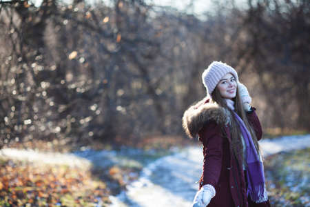 Young happy and beautiful woman walking in the autumn parkの写真素材