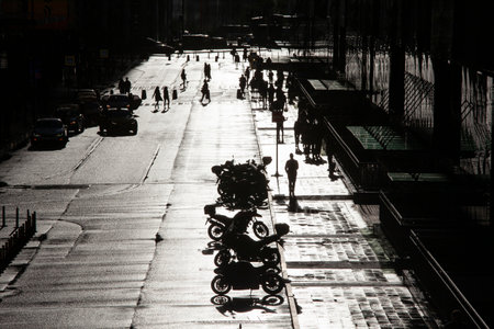 Metropolis street with transport and pedestrians on a sunny eveningの写真素材