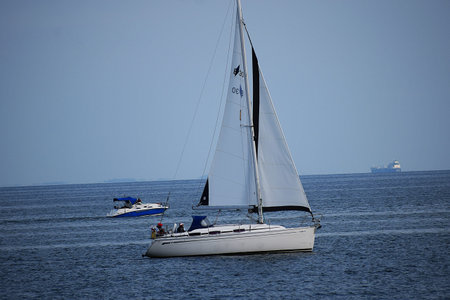 The photo shows a 30 Cruiser yacht, moored or sailing on calm water. The image conveys a sense of...