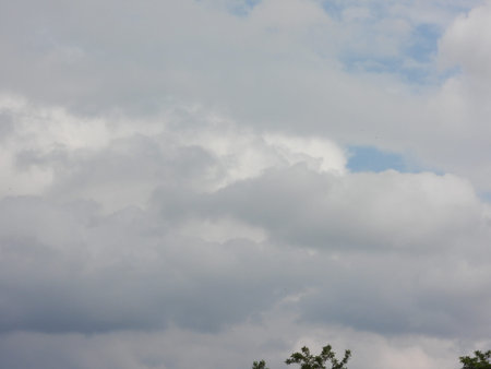The photo shows a sky with dark clouds. The image conveys the mood of a gloomy day and the approach...