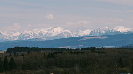 Snowy Carpathians with tall peaks and bright sky.の写真素材