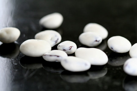 Closeup of yogurt covered raisins on black marbleの写真素材