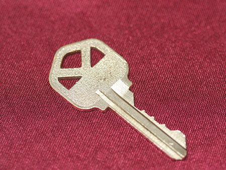 Close up of a gold key on red