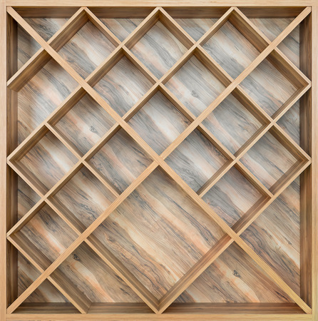Wooden square shelf for wine, or books of boards with a beautiful patternの写真素材
