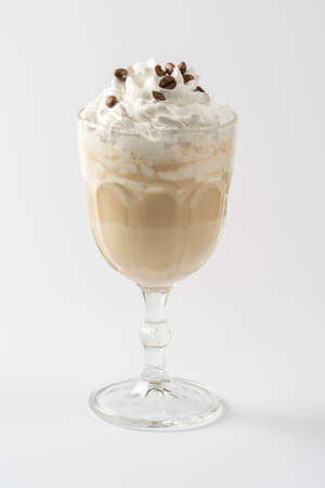 Coffee-chocolate milk protein shake, with whipped cream and caramel syrup on a white plate.の写真素材