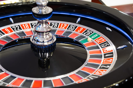 A roulette wheel with a ball dropped into a pocket with the number zero